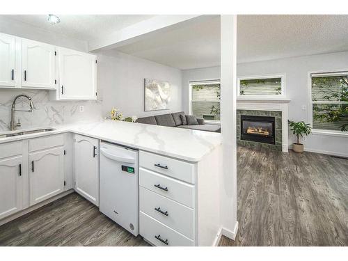 134 Country Hills Villas Nw, Calgary, AB - Indoor Photo Showing Kitchen With Fireplace