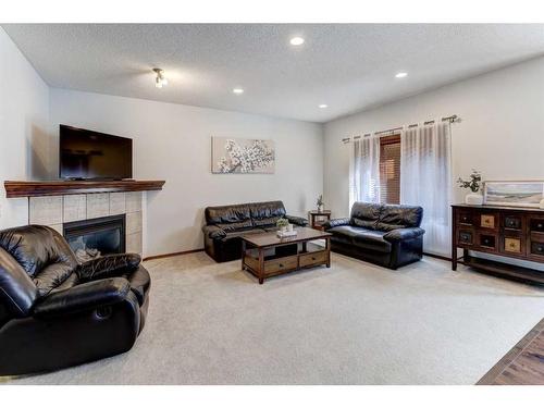 217 Elgin Manor Se, Calgary, AB - Indoor Photo Showing Living Room With Fireplace