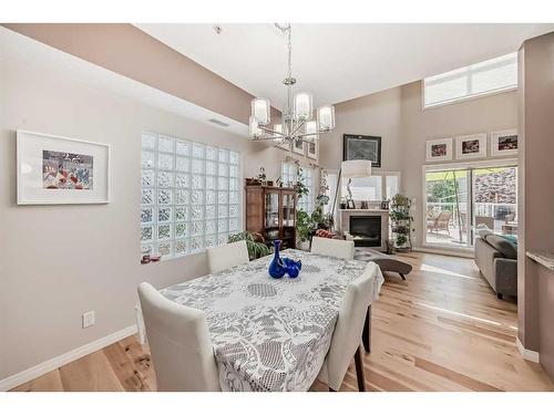 107-6650 Old Banff Coach Road Sw, Calgary, AB - Indoor Photo Showing Dining Room With Fireplace