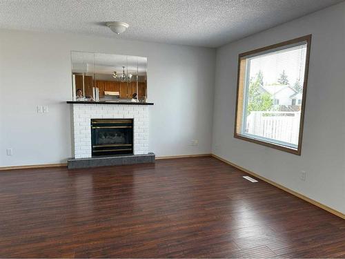 36 Harvest Glen Mews Ne, Calgary, AB - Indoor Photo Showing Living Room With Fireplace