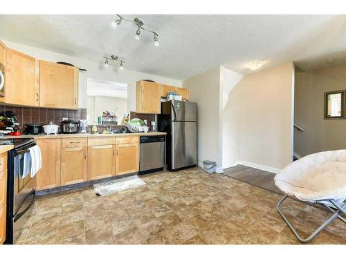 61 Cimarron Vista Gardens, Okotoks, AB - Indoor Photo Showing Kitchen With Double Sink