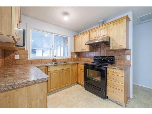 351 Penswood Way Se, Calgary, AB - Indoor Photo Showing Kitchen With Double Sink