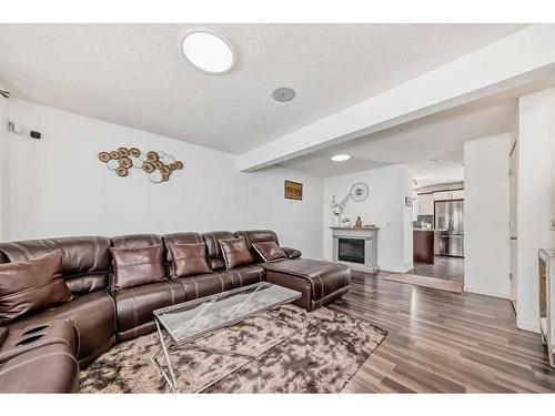 504 Saddlecrest Boulevard Ne, Calgary, AB - Indoor Photo Showing Living Room With Fireplace