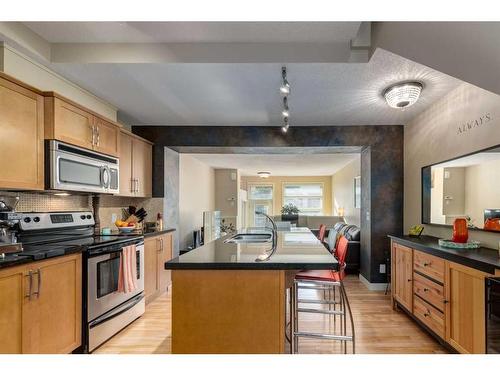 219 Aspen Hills Villas Sw, Calgary, AB - Indoor Photo Showing Kitchen With Stainless Steel Kitchen With Double Sink