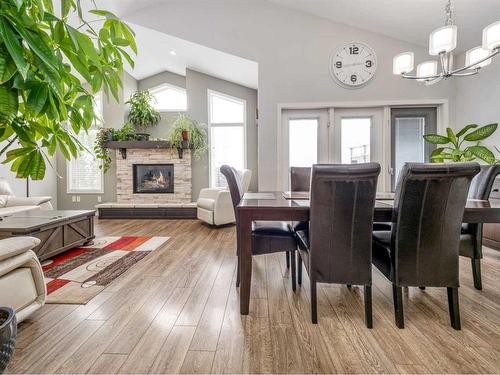 667 Marie Van Haarlem Crescent North, Lethbridge, AB - Indoor Photo Showing Dining Room With Fireplace