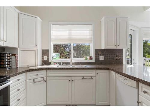 704 Woodside Drive Nw, Airdrie, AB - Indoor Photo Showing Kitchen With Double Sink