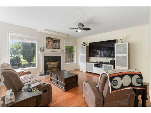 704 Woodside Drive Nw, Airdrie, AB - Indoor Photo Showing Living Room With Fireplace