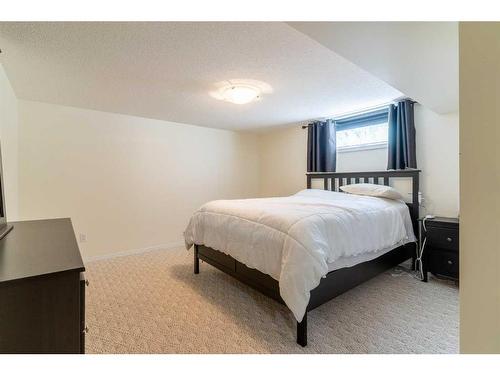 704 Woodside Drive Nw, Airdrie, AB - Indoor Photo Showing Bedroom