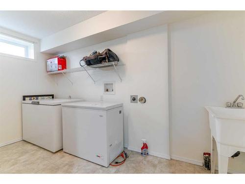 704 Woodside Drive Nw, Airdrie, AB - Indoor Photo Showing Laundry Room