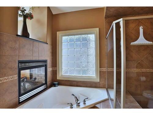 53 Westpoint Way Sw, Calgary, AB - Indoor Photo Showing Bathroom With Fireplace