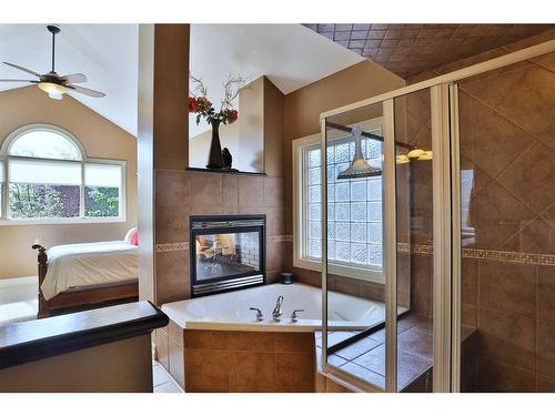 53 Westpoint Way Sw, Calgary, AB - Indoor Photo Showing Bathroom With Fireplace