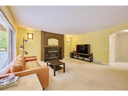 132 Evergreen Close Sw, Calgary, AB - Indoor Photo Showing Living Room With Fireplace