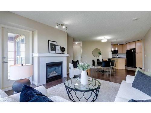 408-5115 Richard Road Sw, Calgary, AB - Indoor Photo Showing Living Room With Fireplace