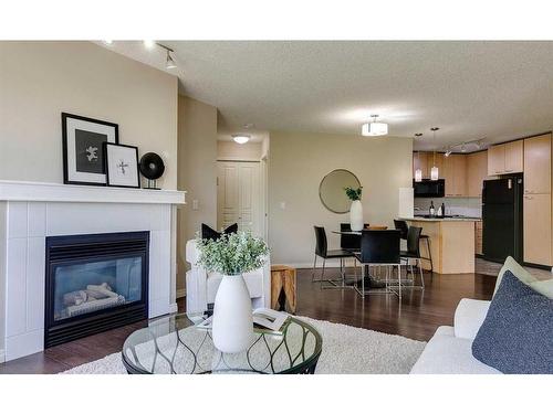 408-5115 Richard Road Sw, Calgary, AB - Indoor Photo Showing Living Room With Fireplace