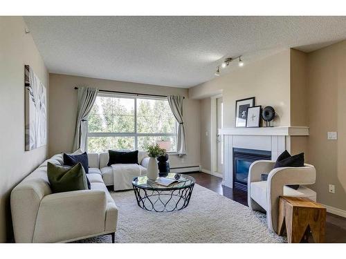 408-5115 Richard Road Sw, Calgary, AB - Indoor Photo Showing Living Room With Fireplace