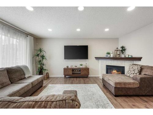 13 Brightondale Park Se, Calgary, AB - Indoor Photo Showing Living Room With Fireplace