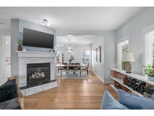 15 Cougar Ridge View Sw, Calgary, AB - Indoor Photo Showing Living Room With Fireplace