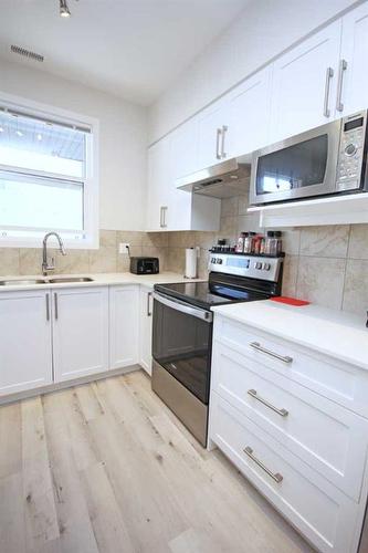 204-245 Redstone Walk Ne, Calgary, AB - Indoor Photo Showing Kitchen With Double Sink