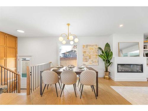 1211 Lake Twintree Drive Se, Calgary, AB - Indoor Photo Showing Dining Room With Fireplace