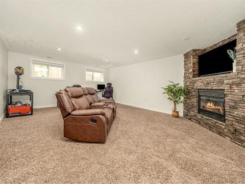 148 Heritage Rd, Magrath, AB - Indoor Photo Showing Living Room With Fireplace