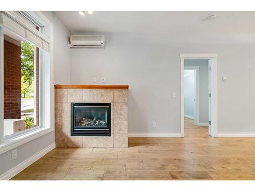 1107-24 Hemlock Crescent Sw, Calgary, AB - Indoor Photo Showing Living Room With Fireplace