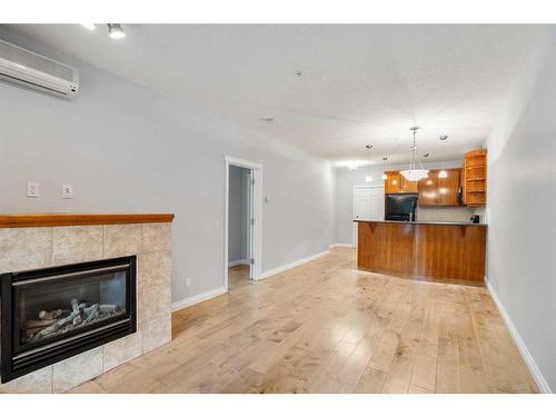 1107-24 Hemlock Crescent Sw, Calgary, AB - Indoor Photo Showing Living Room With Fireplace