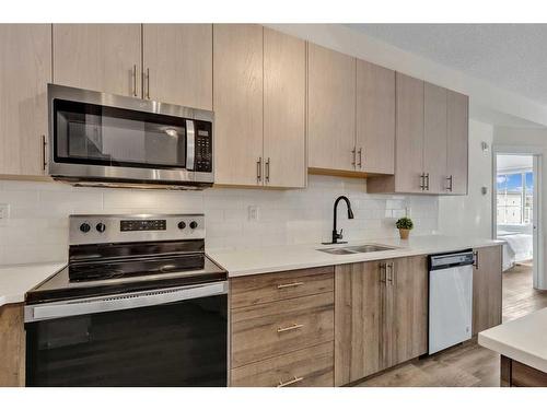 3417-298 Sage Meadows Park Nw, Calgary, AB - Indoor Photo Showing Kitchen With Stainless Steel Kitchen With Double Sink With Upgraded Kitchen