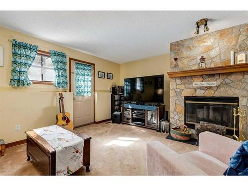 107 Scenic Glen Place Nw, Calgary, AB - Indoor Photo Showing Living Room With Fireplace