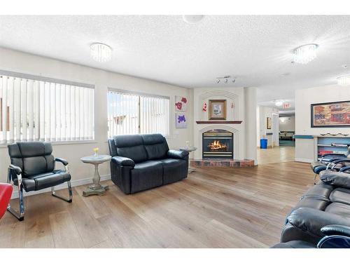 2327-1818 Simcoe Boulevard Sw, Calgary, AB - Indoor Photo Showing Living Room With Fireplace