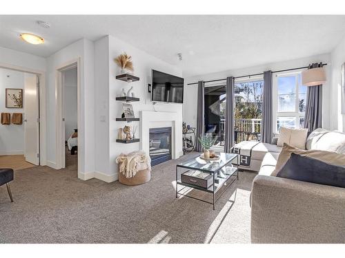 418-35 Richard Court Sw, Calgary, AB - Indoor Photo Showing Living Room With Fireplace