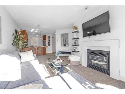 418-35 Richard Court Sw, Calgary, AB - Indoor Photo Showing Living Room With Fireplace