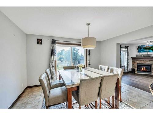 105 Aspenmere Place, Chestermere, AB - Indoor Photo Showing Dining Room With Fireplace