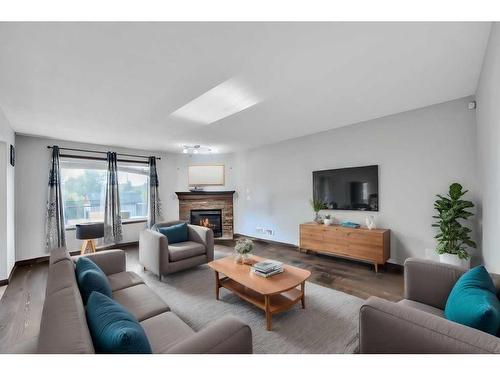 105 Aspenmere Place, Chestermere, AB - Indoor Photo Showing Living Room With Fireplace