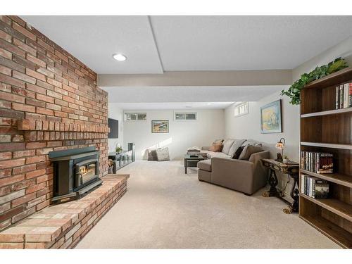 303 Woodpark Place, Calgary, AB - Indoor Photo Showing Living Room With Fireplace