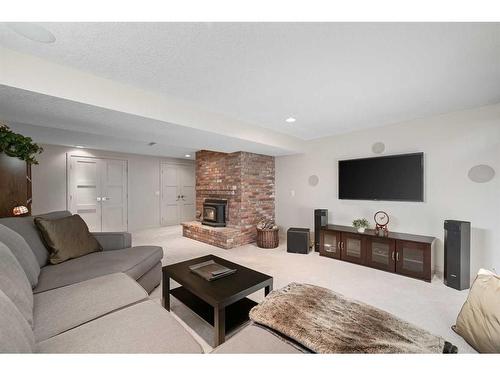 303 Woodpark Place, Calgary, AB - Indoor Photo Showing Living Room With Fireplace