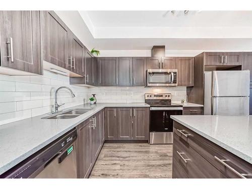 6217-151 Legacy Main Street Se, Calgary, AB - Indoor Photo Showing Kitchen With Stainless Steel Kitchen With Double Sink