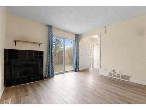 213-5404 10 Avenue Se, Calgary, AB - Indoor Photo Showing Living Room With Fireplace