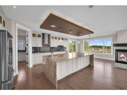 16053 243 Avenue East, Rural Foothills County, AB - Indoor Photo Showing Kitchen With Fireplace