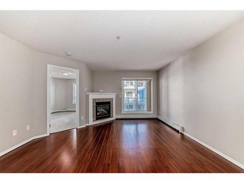 317-260 Shawville Way Se, Calgary, AB - Indoor Photo Showing Living Room With Fireplace