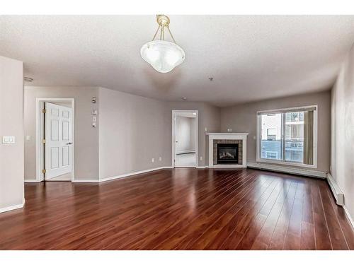 317-260 Shawville Way Se, Calgary, AB - Indoor Photo Showing Living Room With Fireplace