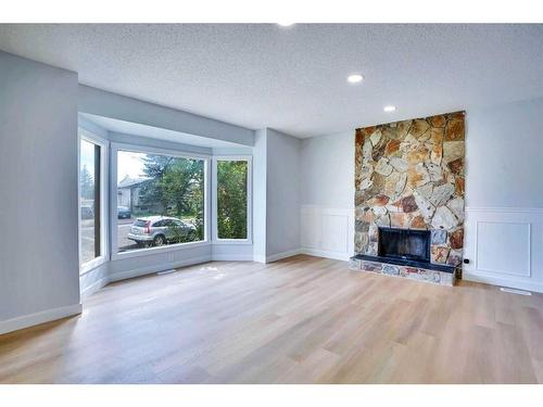 59 Whitehaven Road Ne, Calgary, AB - Indoor Photo Showing Living Room With Fireplace