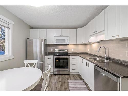 139 Woodsman Lane Sw, Calgary, AB - Indoor Photo Showing Kitchen With Stainless Steel Kitchen With Double Sink