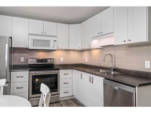 139 Woodsman Lane Sw, Calgary, AB - Indoor Photo Showing Kitchen With Stainless Steel Kitchen With Double Sink