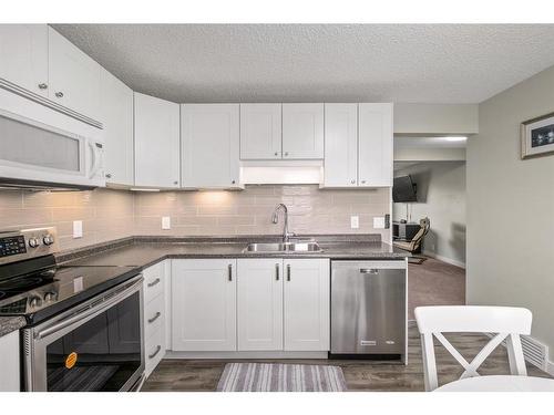 139 Woodsman Lane Sw, Calgary, AB - Indoor Photo Showing Kitchen With Stainless Steel Kitchen With Double Sink