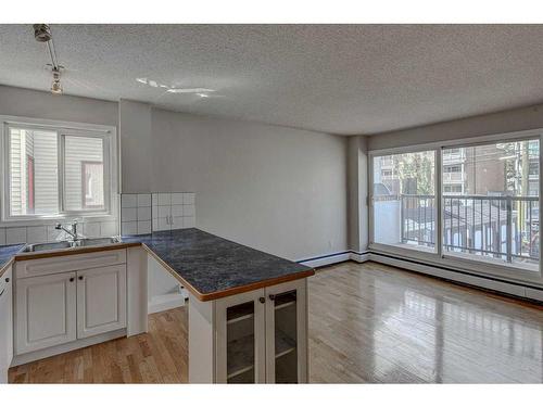 203-126 24 Avenue Sw, Calgary, AB - Indoor Photo Showing Kitchen With Double Sink