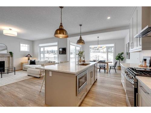 30 Fireside Point, Cochrane, AB - Indoor Photo Showing Kitchen With Fireplace With Upgraded Kitchen