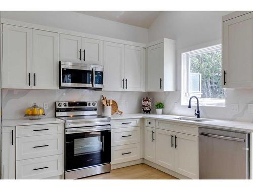 16 Hawktree Close Nw, Calgary, AB - Indoor Photo Showing Kitchen With Double Sink