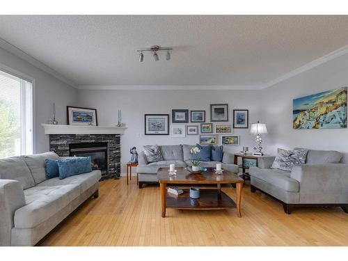 51 Everridge Villas Sw, Calgary, AB - Indoor Photo Showing Living Room With Fireplace