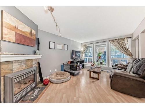 28-5315 53 Avenue Nw, Calgary, AB - Indoor Photo Showing Living Room With Fireplace