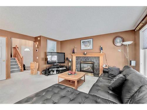 132 Tuscany Hills Circle Nw, Calgary, AB - Indoor Photo Showing Living Room With Fireplace